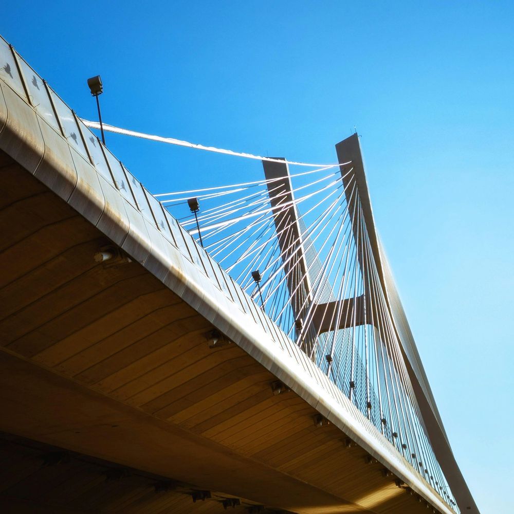 Modern cable-stayed bridge against a blue sky